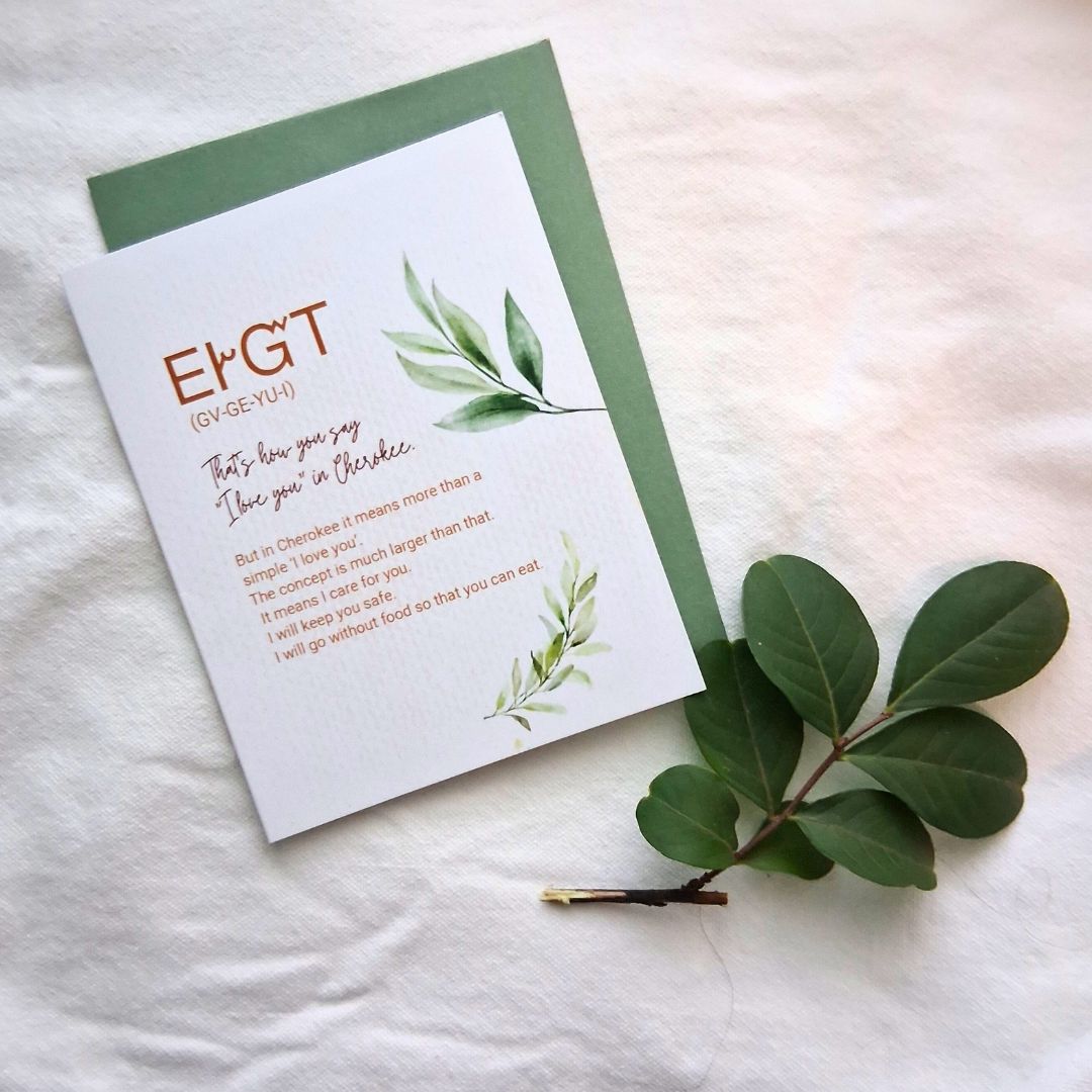Greeting card with green leaves on a white background