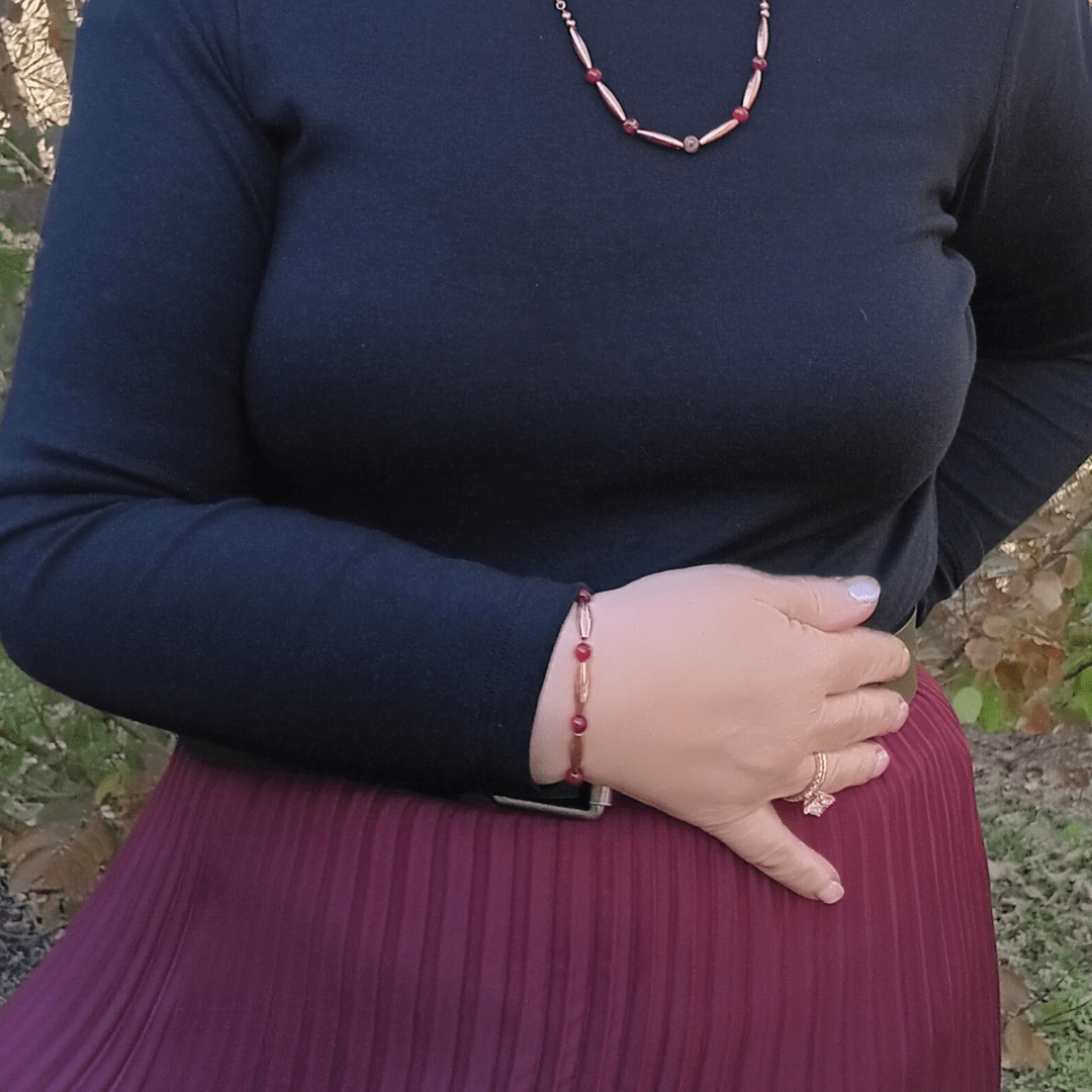 Woman wearing the Cardinal Unali red jasper and copper Cherokee friendship bracelet