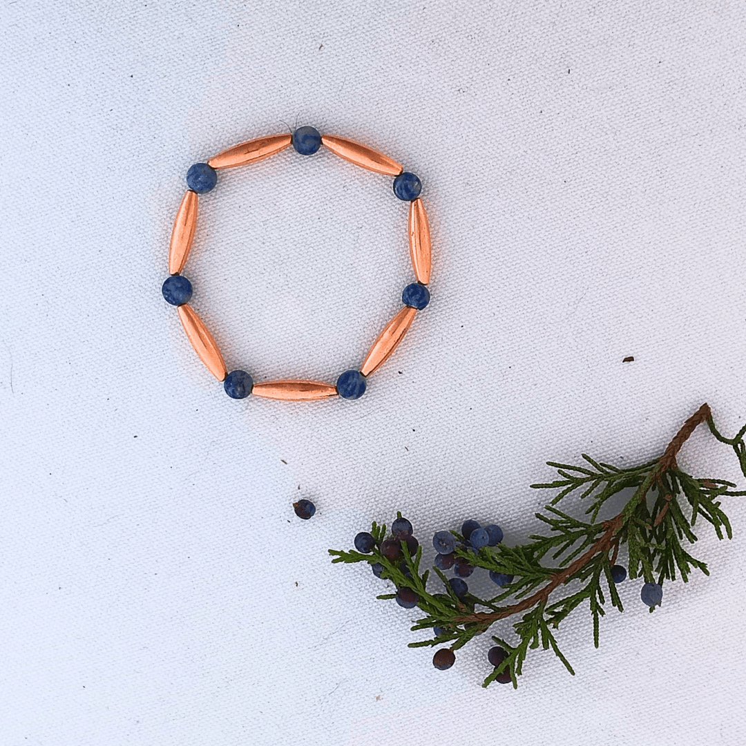 Copper and blue bead bracelet with cedar branch