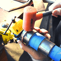 Joshua Stice hand-forging the Ross Copper Cuff with a hammer